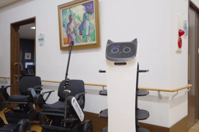 BellaBot in senior living environment with wheel chairs