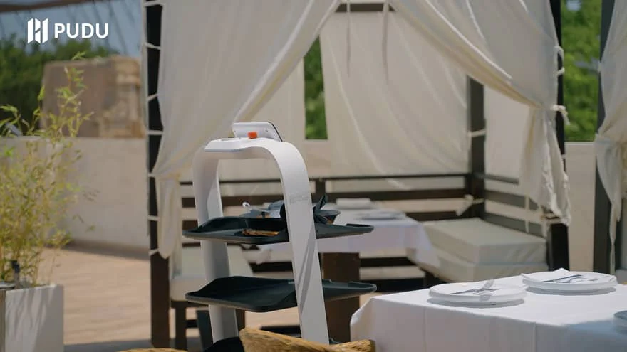 pudu robots delivery food to guests outdoors