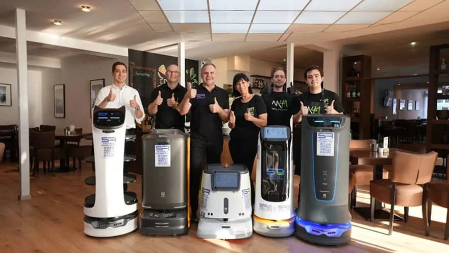 smiling employees with robots
